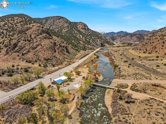 bird's eye view with a water and mountain view