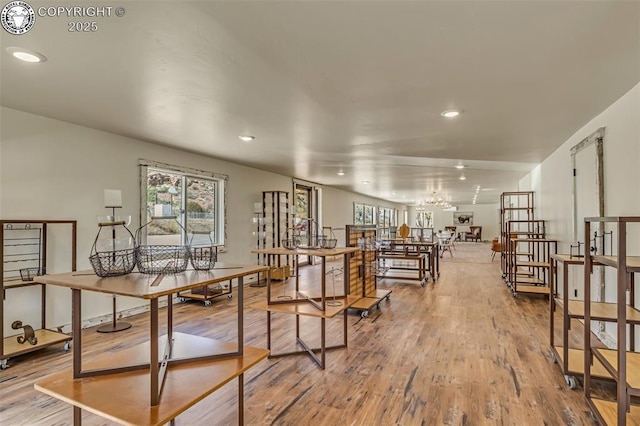 dining space featuring a notable chandelier, recessed lighting, and wood finished floors