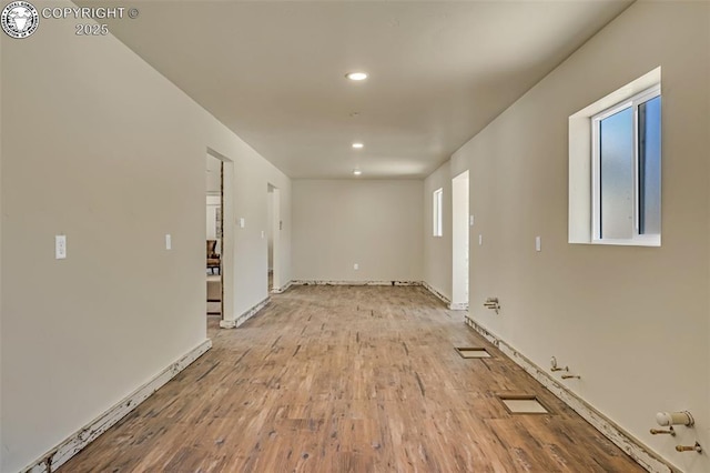 spare room featuring visible vents, recessed lighting, wood finished floors, and baseboards