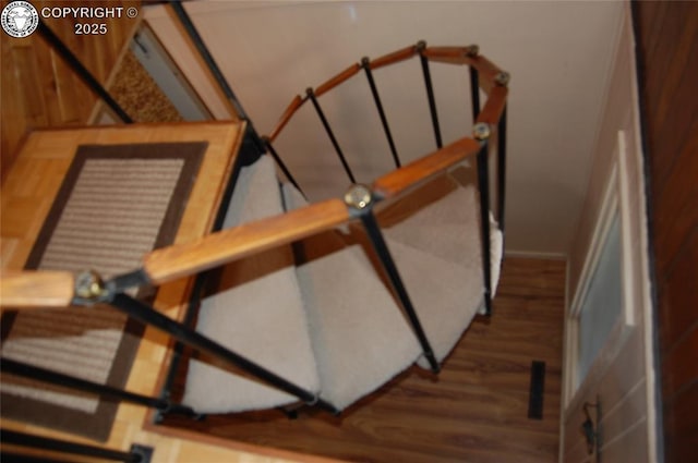 staircase with hardwood / wood-style flooring