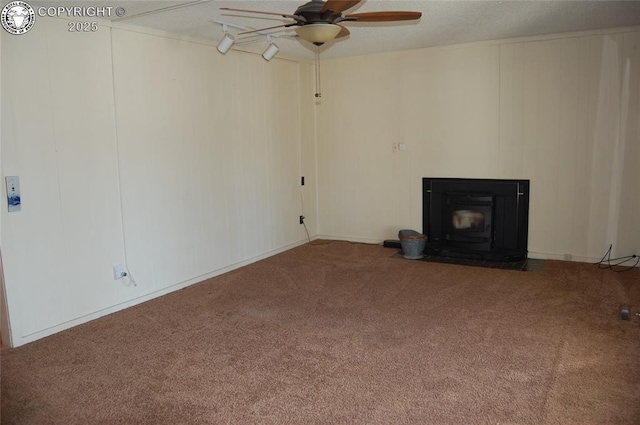 unfurnished living room featuring ceiling fan and carpet