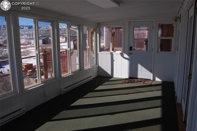 sunroom with a baseboard heating unit