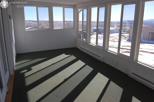 unfurnished sunroom with a baseboard heating unit