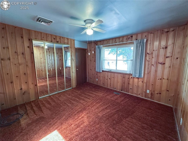 720 Whipple Ave, Canon City, CO 81212 - carpeted empty room featuring wooden walls and ceiling fan