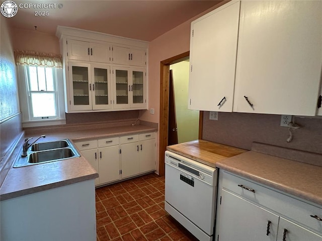 720 Whipple Ave, Canon City, CO 81212 - kitchen with brick patterned flooring, white cabinets, light countertops, and white dishwasher