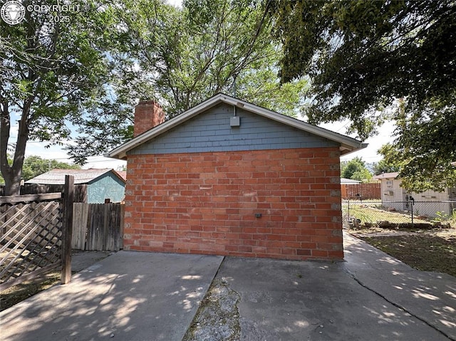 720 Whipple Ave, Canon City, CO 81212 - view of side of property with a chimney and brick siding