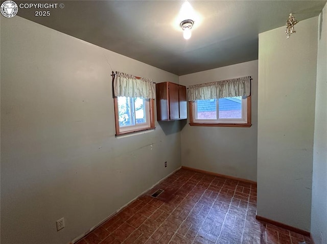 720 Whipple Ave, Canon City, CO 81212 - empty room featuring baseboards and brick patterned flooring