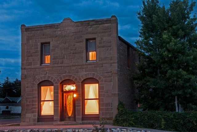 view of back house at dusk