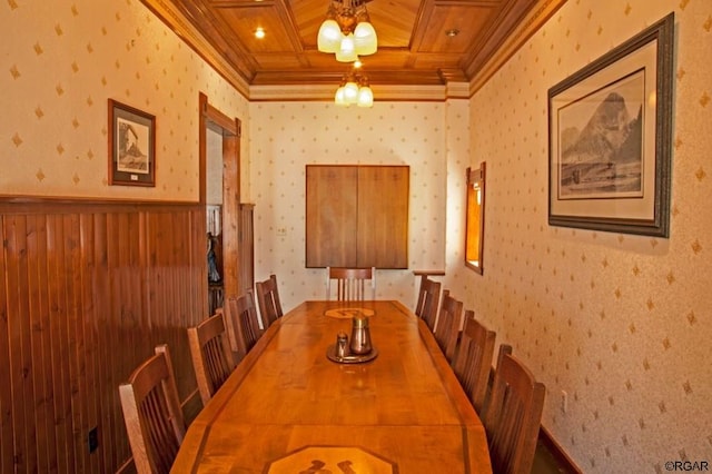 dining space featuring crown molding, coffered ceiling, and beam ceiling