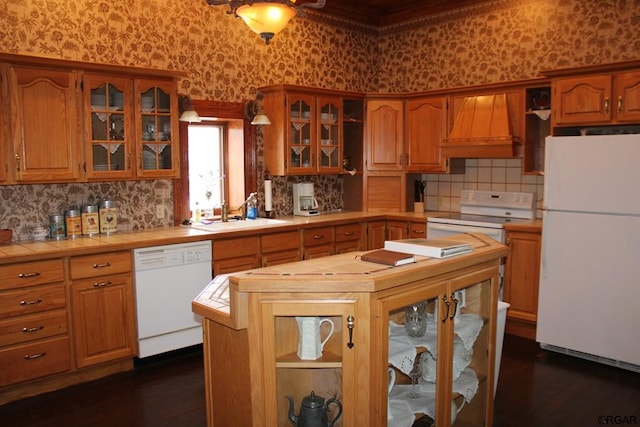 kitchen featuring a kitchen island, sink, tile counters, custom range hood, and white appliances