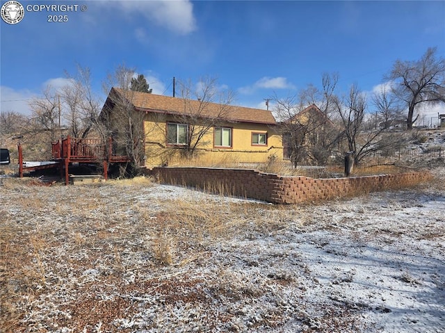 view of property exterior featuring a deck