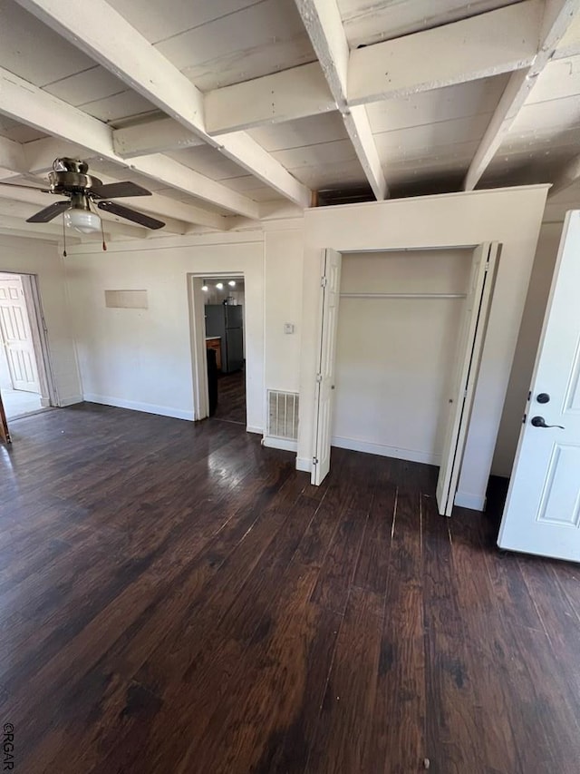 interior space with ceiling fan, beam ceiling, and dark hardwood / wood-style flooring