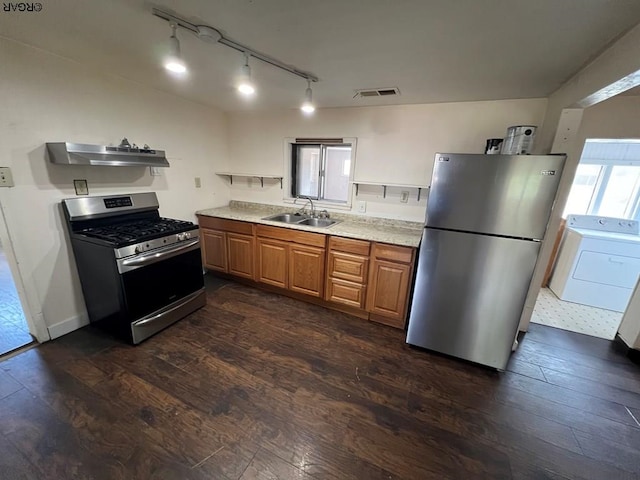 kitchen with sink, washer / dryer, stainless steel appliances, and dark hardwood / wood-style floors