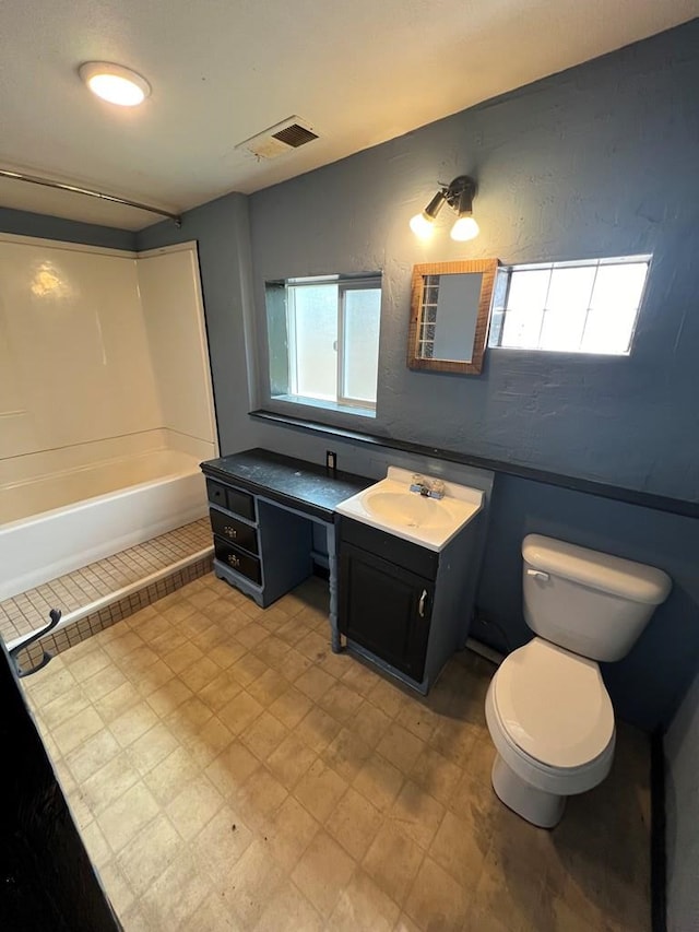 full bathroom featuring shower / bath combination, vanity, and toilet