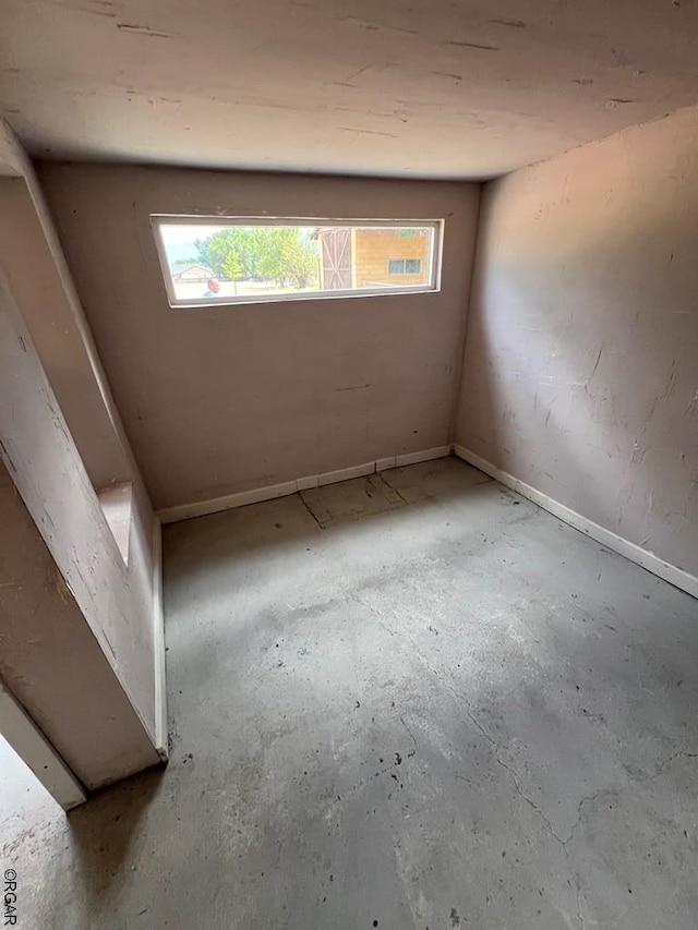 spare room with a wealth of natural light and concrete floors