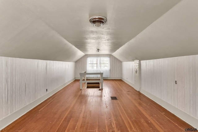 bonus room featuring hardwood / wood-style floors and vaulted ceiling