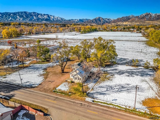 snowy aerial view featuring a mountain view