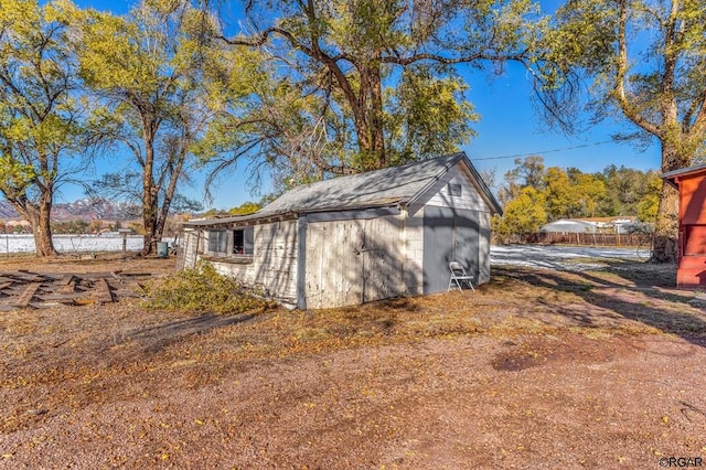 view of side of home featuring an outdoor structure