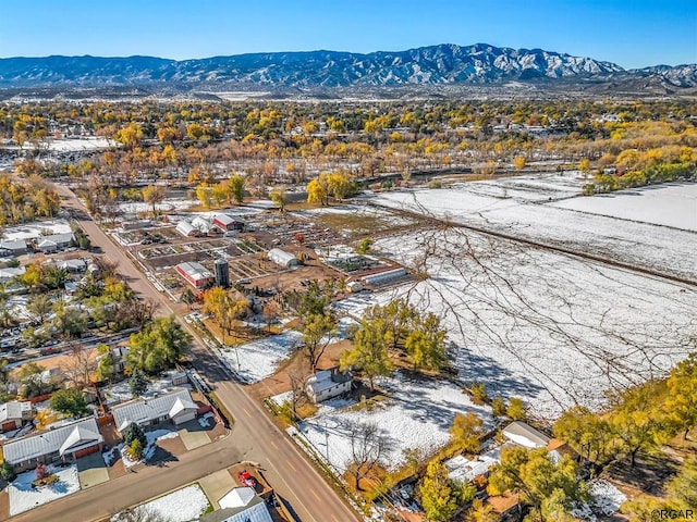 snowy aerial view with a mountain view