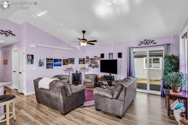 202 First St, Silver Cliff, CO 81252 - living room with light wood finished floors, a ceiling fan, a wood stove, and high vaulted ceiling