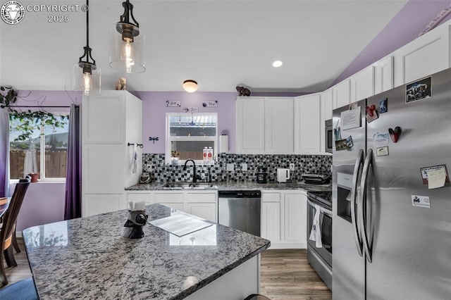 202 First St, Silver Cliff, CO 81252 - kitchen with stainless steel appliances, white cabinets, decorative backsplash, light stone countertops, and light wood-style floors
