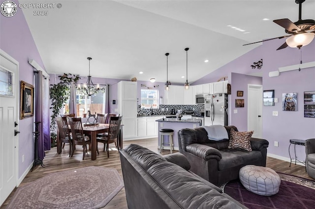 202 First St, Silver Cliff, CO 81252 - living area featuring vaulted ceiling, a chandelier, a ceiling fan, light wood-style flooring, and recessed lighting