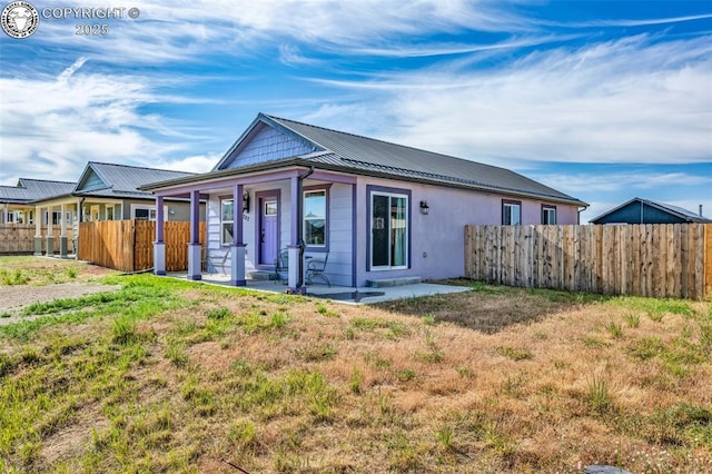 202 First St, Silver Cliff, CO 81252 - rear view of house featuring a metal roof, a porch, and a standing seam roof