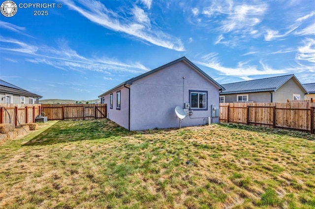 202 First St, Silver Cliff, CO 81252 - rear view of house featuring a fenced backyard and stucco siding