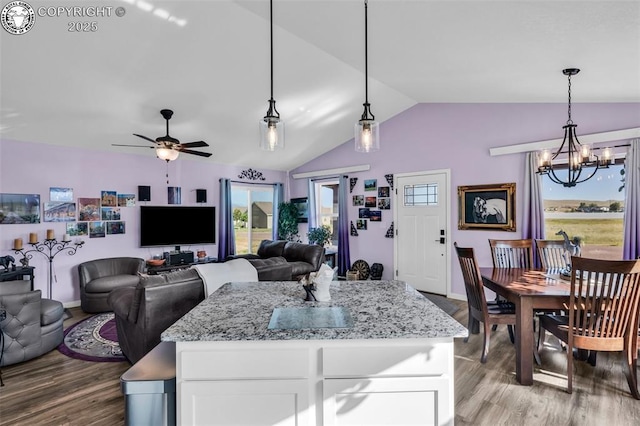 202 First St, Silver Cliff, CO 81252 - kitchen featuring a chandelier, wood finished floors, lofted ceiling, white cabinetry, and open floor plan