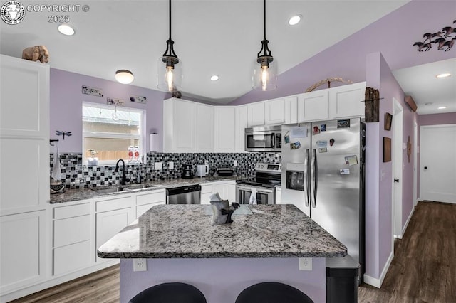 202 First St, Silver Cliff, CO 81252 - kitchen featuring stainless steel appliances, tasteful backsplash, white cabinets, a breakfast bar area, and light stone counters