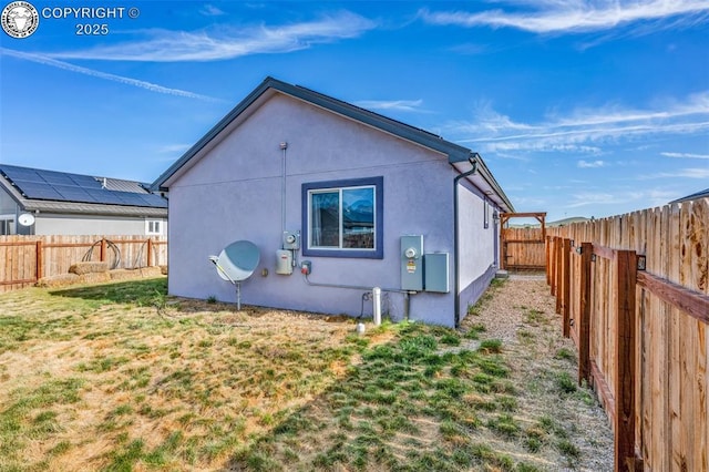 202 First St, Silver Cliff, CO 81252 - back of property featuring stucco siding and a fenced backyard