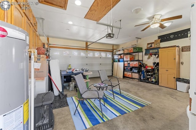 garage with a ceiling fan, a garage door opener, and water heater