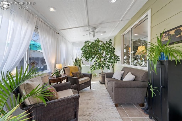 sunroom featuring a ceiling fan