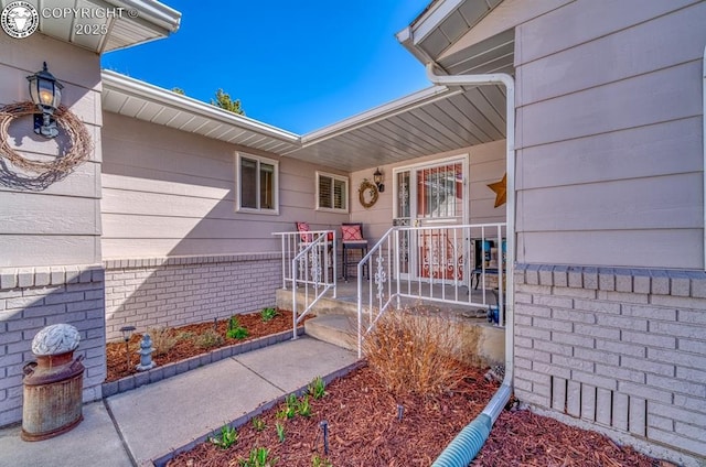 doorway to property with brick siding