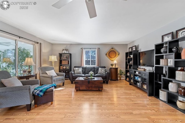 living area with light wood finished floors and ceiling fan