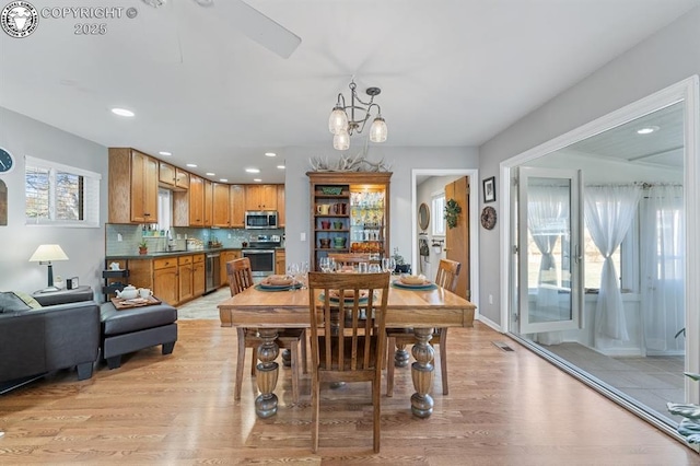 dining area with recessed lighting, visible vents, light wood finished floors, and a chandelier