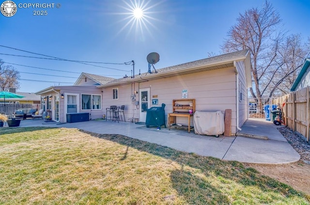 back of house with a patio area, fence, and a lawn