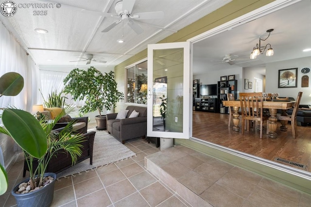 sunroom with visible vents and ceiling fan