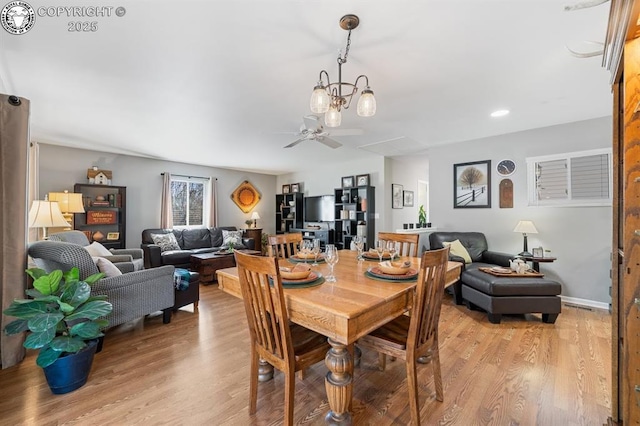 dining space featuring light wood-style flooring, baseboards, and a ceiling fan