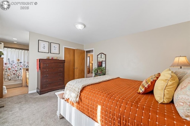 bedroom with baseboards, carpet floors, and a closet