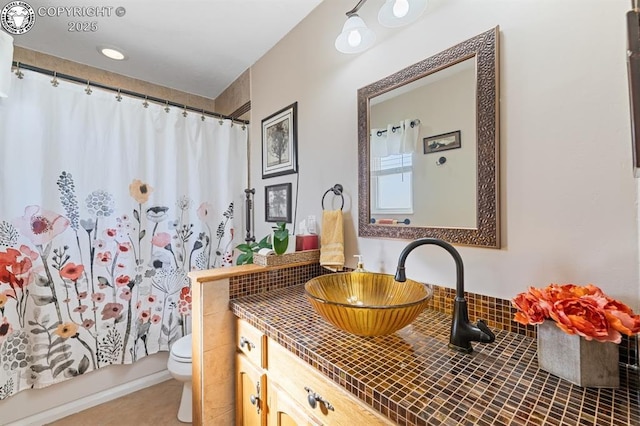 bathroom with tile patterned floors, toilet, vanity, and shower / bathtub combination with curtain