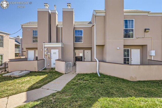 3210 Van Teylingen Dr, Colorado Springs, CO 80917 - view of front of home with stucco siding and a chimney