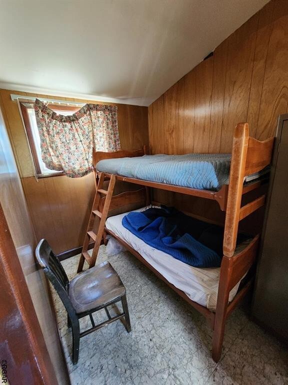 bedroom with wooden walls