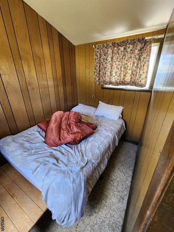 bedroom featuring wood walls