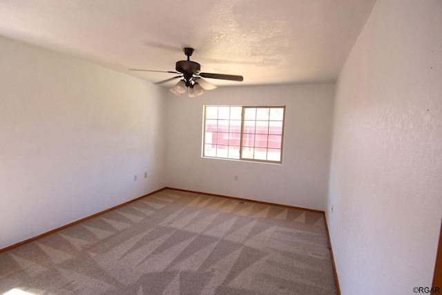 empty room featuring ceiling fan and carpet flooring