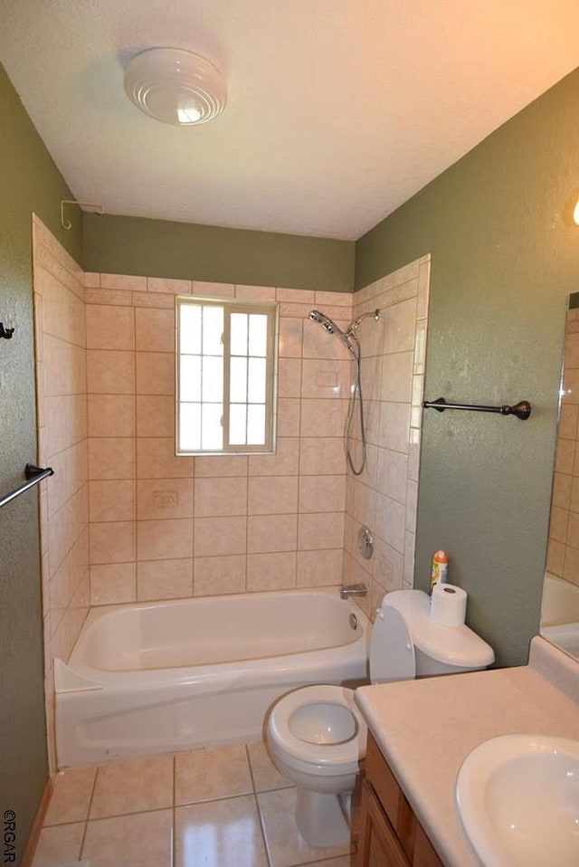 full bathroom with tile patterned floors, toilet, tiled shower / bath combo, and vanity