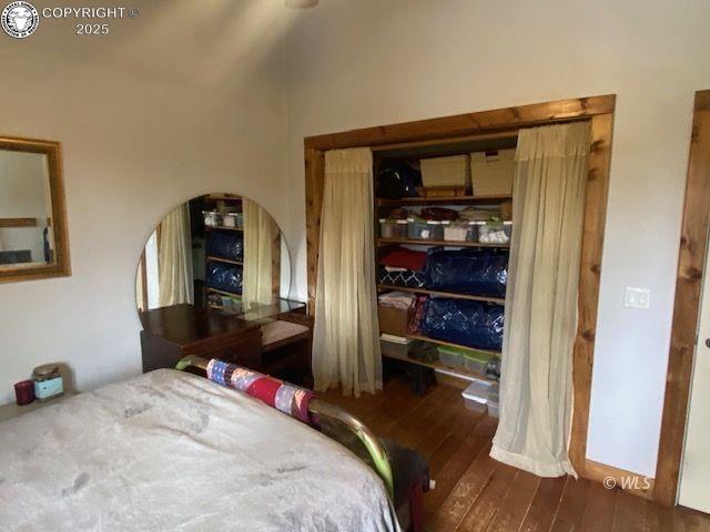 bedroom with dark wood-type flooring