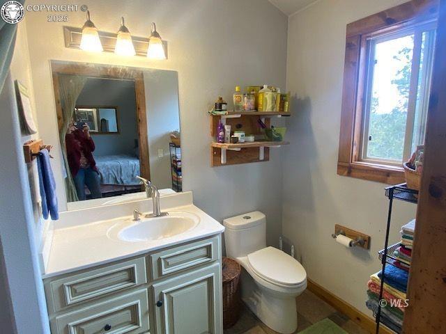 bathroom featuring vanity and toilet