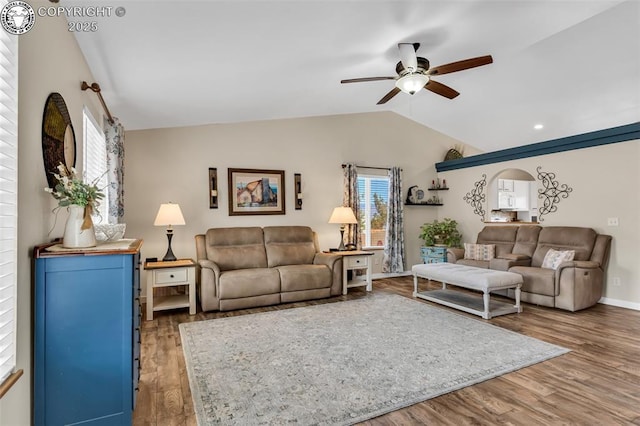 living room with baseboards, lofted ceiling, wood finished floors, and a ceiling fan