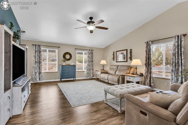 living area with lofted ceiling, baseboards, dark wood-type flooring, and ceiling fan